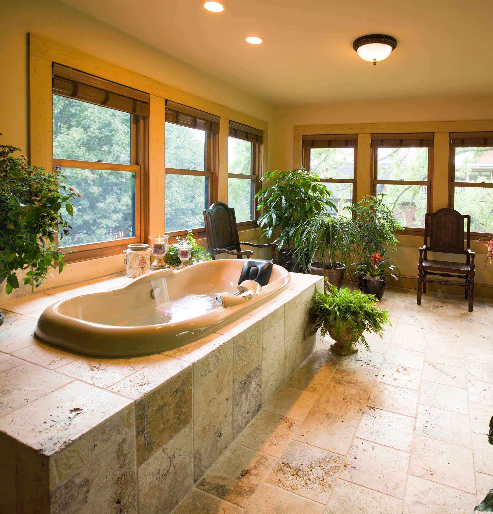 Luxury bath in Cloisters Suite at Inn on Montford in Asheville, NC. A spa room with multi-jet two-person Whirlpool with shiatsu massage, airbath, fireplace, and heated marble floors.