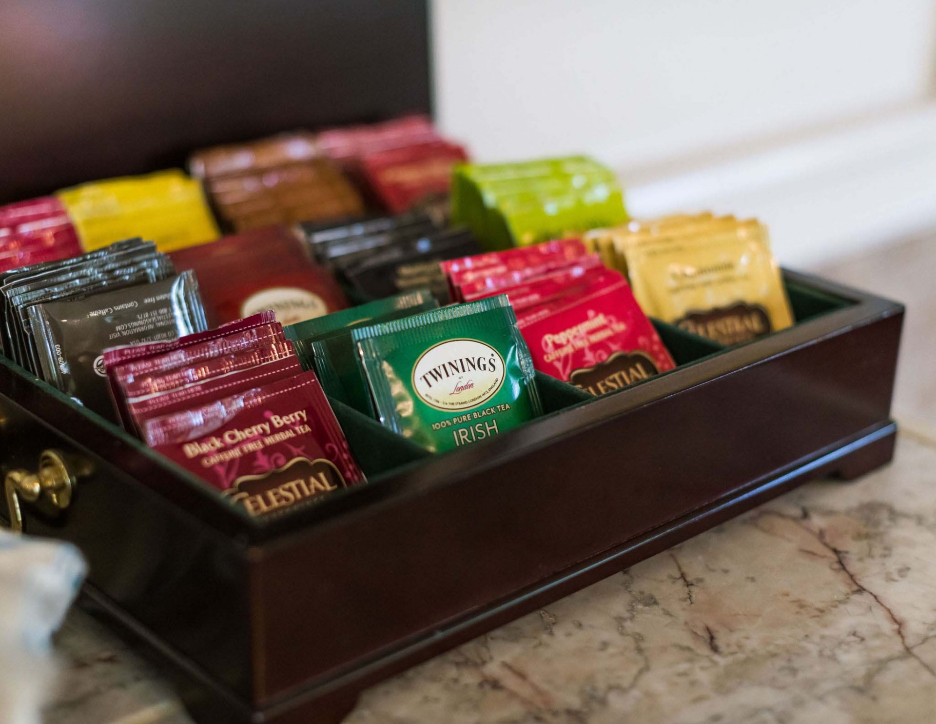 A close-up of a tea box with a selection of Twinnings tea bags.