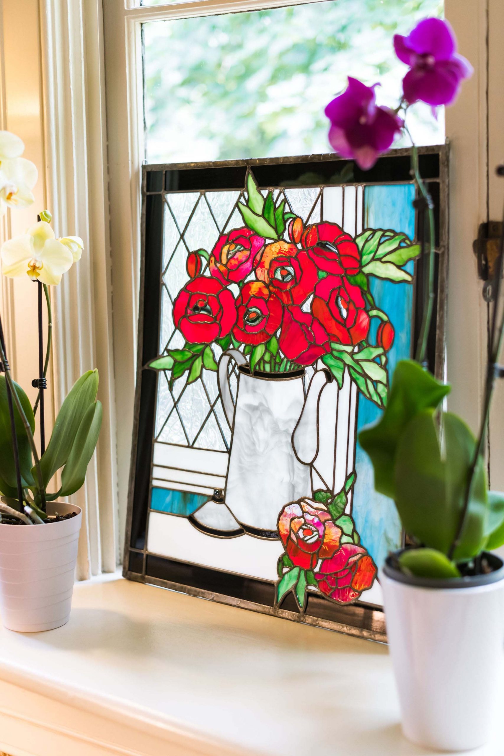 A close-up of purple orchids on the window sill of the sun room.