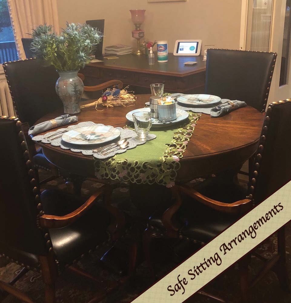 Dining room table, chairs & place settings deomnstratinging social distancing best practices