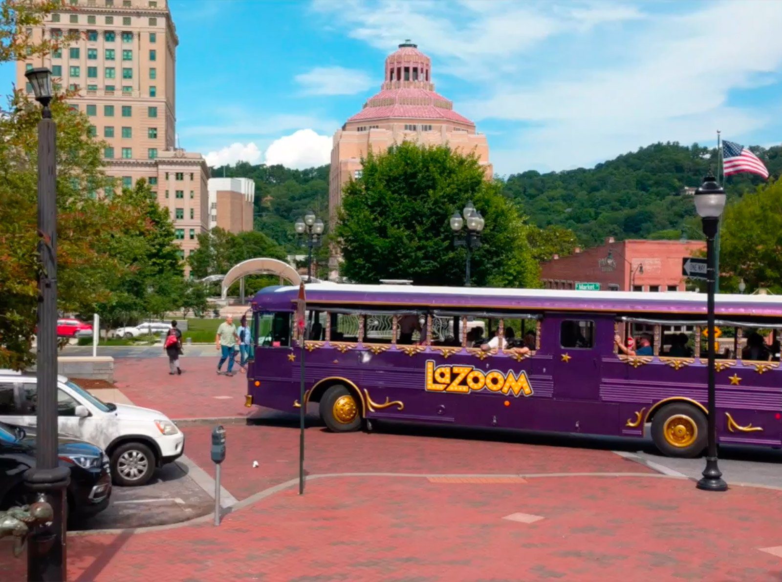 A purple LaZoom bus parked in downtown Asheville