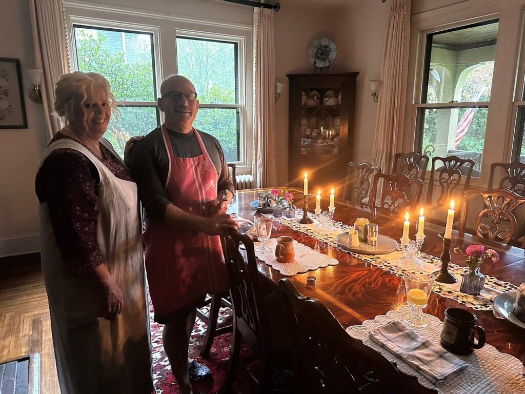 The innkeepers at 1900 Inn on Montford serving breakfast by candle light during Hurricane Helene